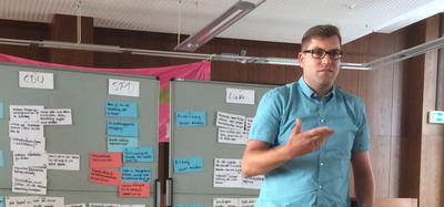 Matthias Borowiak steht vor zwei Flipcharts.