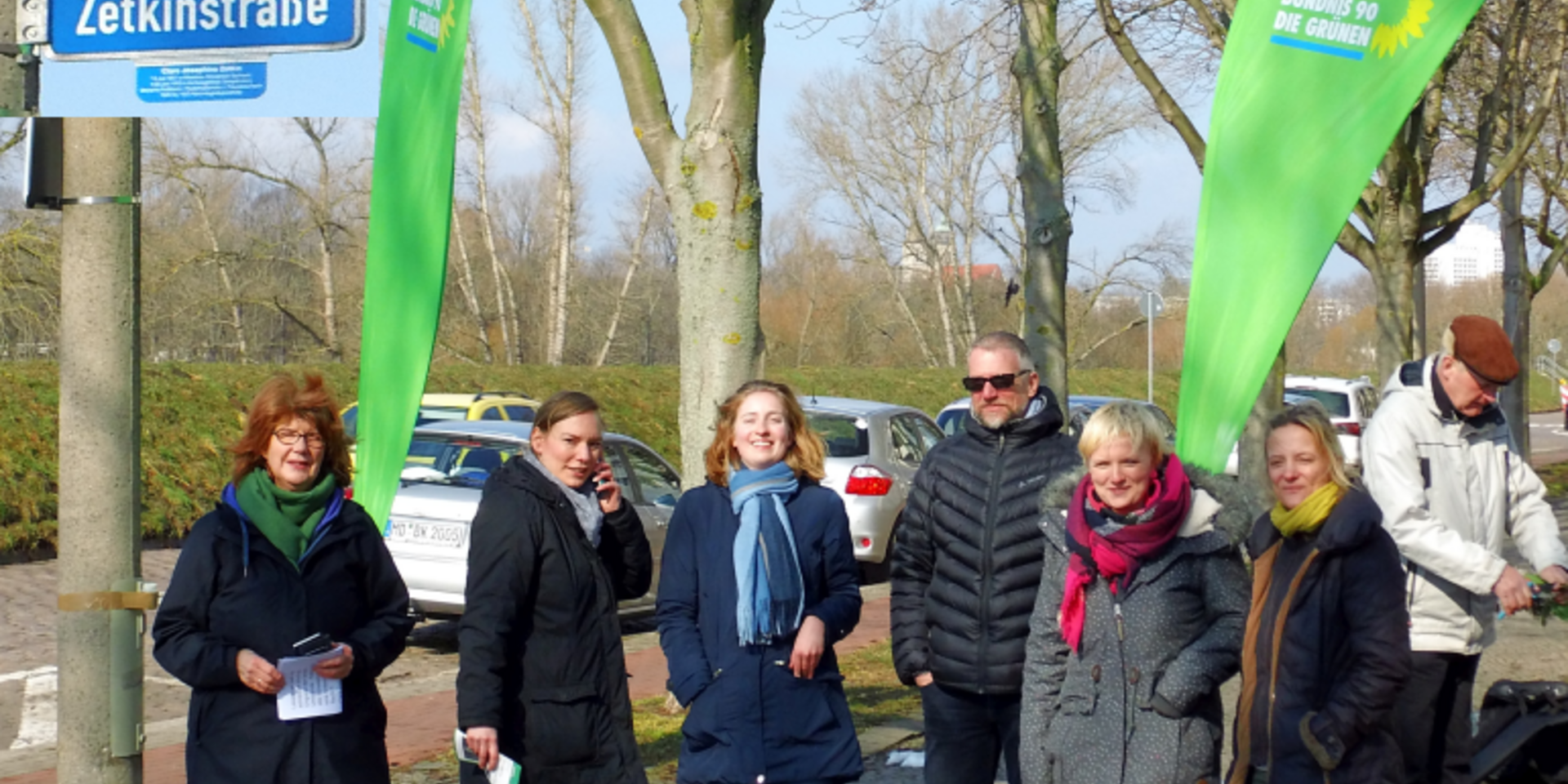 Heike Ponitka, Julia Bohlander und weitere Gäste stehen am Straßenschild in der Clara-Zetkin-Straße.